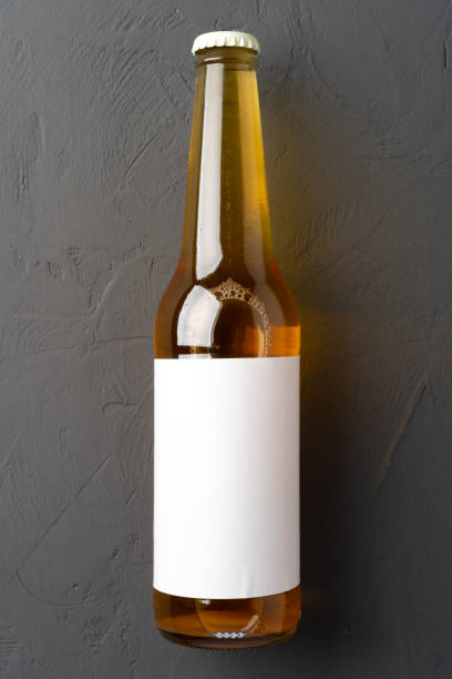 istock Beer bottle, on gray stone background, top view, with copy space for text 1369940377