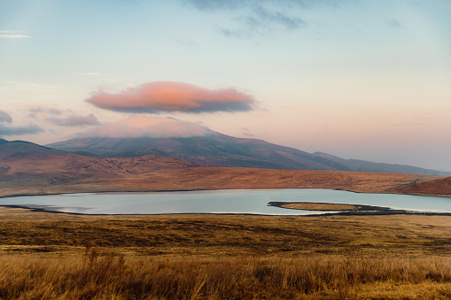 Dramatic view of the bright colorful sunrise above the volcanic crater with large lake in Ngorongoro National Park, East Africa