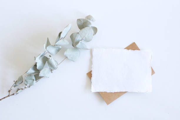 istock Bright female spring template mockup scene with red greeting card and eucalyptus leaves on white background table wedding style. 1369940465