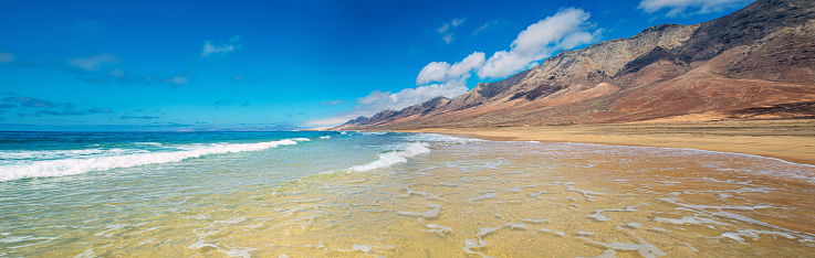 Cofete, Fuerteventura, Spanien. Large panorama with transparent, clean water.