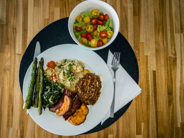 istock White dish with healthy food and salad. 1369943554