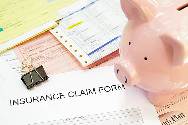 istock Insurance claim form and a pig safe box 136994396