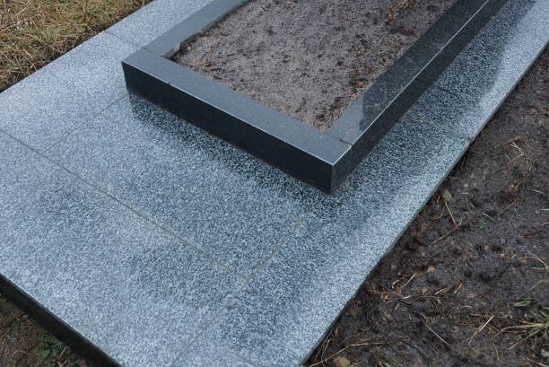 istock gray black marble gravestone in brown earth 1369943994