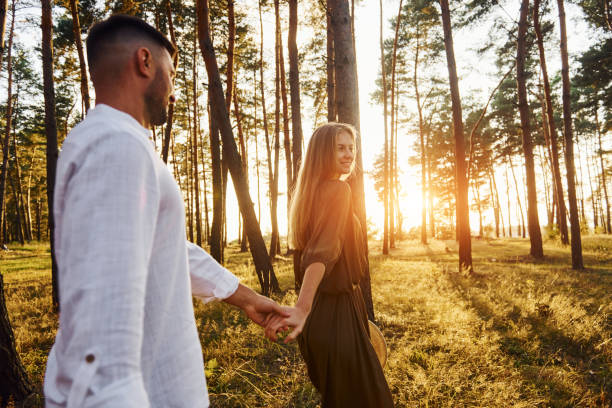 scène non urbaine. un couple heureux est à l’extérieur dans la forêt pendant la journée - non urban scene photos et images de collection