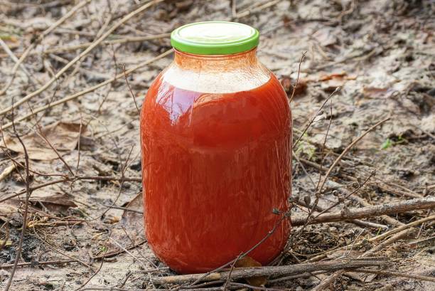 istock one large glass jar with red tomato juice 1369945088