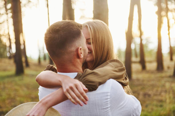 istock Happy couple is outdoors in the forest at daytime 1369945091