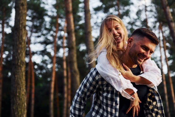 istock Happy couple is outdoors in the forest at daytime 1369945228