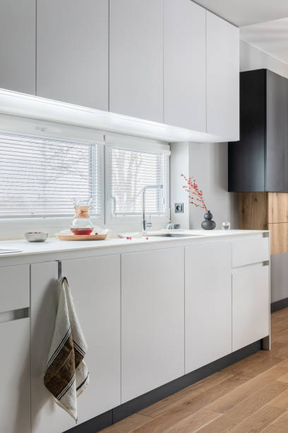 istock Minimalistic and modern white kitchen interior with furniture and kitchen accessories in stylish home decor. Windows. Details. Template. 1369945612