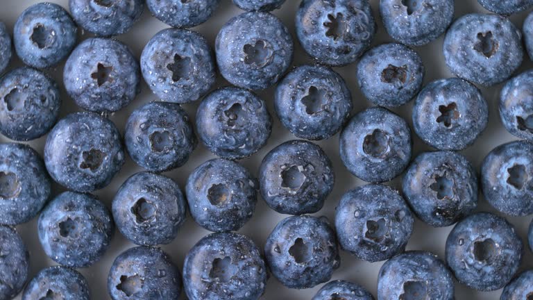 SLO MO LD Blueberries rotating on a white table