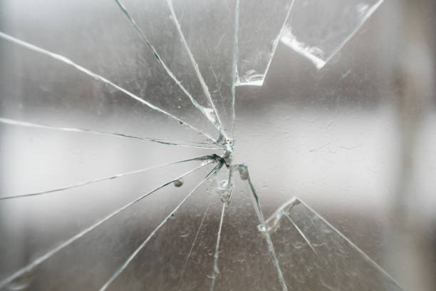 istock Glass broken by hooligans in a metal-plastic window, close-up 1369947499