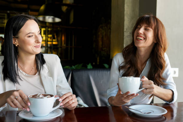 istock Happy young women friends having coffee break while relaxing at the cafe 1369948962