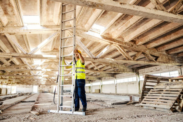 istock A construction site worker preparing to climb ladders at site. 1369949459