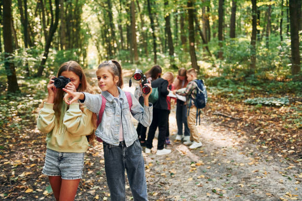 istock Looking for a path. Kids in green forest at summer daytime together 1369949566