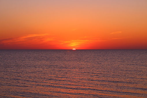 Sunset, also known as sundown, is the daily disappearance of the Sun below the horizon due to Earth's rotation.