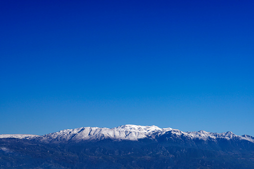 Snowy peak of mountains and blue sky in Fethiye, Turkey.