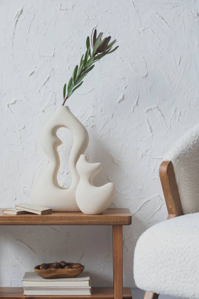 istock MMinimalist living room interior composition with handmade vases, side table, fluffy armchair and personal accessories. Structure wall. Copy space. Wallpaper. Template.