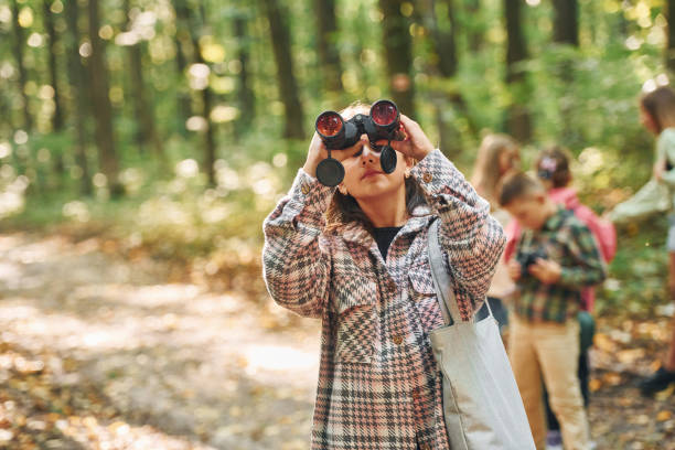 istock Having a walk. Kids in green forest at summer daytime together 1369950198