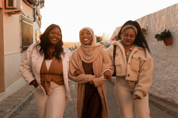 istock Cheerful friends smiling while walking together outdoors 1369950962