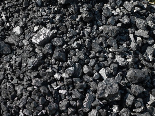 istock Barbecue grill coal close up. Black charcoal texture background 1369951004