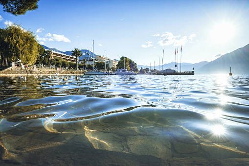 low angle view on the Lago Maggiore in Locarno in the morning sun with marina in the background