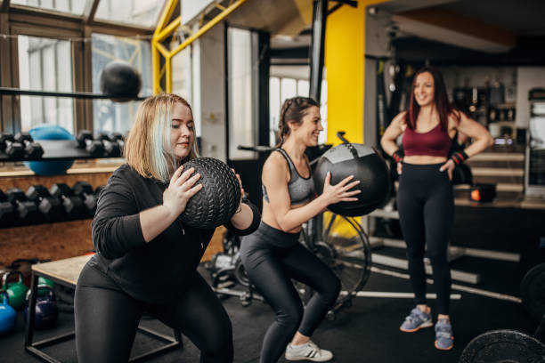 istock Fitness trainer training two women 1369951589