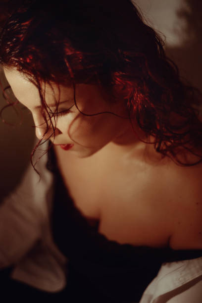 istock Redhead young woman with wet hair posing while looking down 1369951655