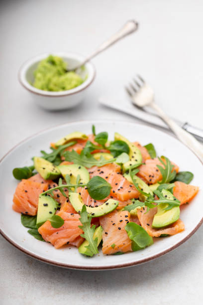 istock Fresh salmon salad with avocado,  for keto and low carb diet. Rusty background, top view, copy space. 1369953042