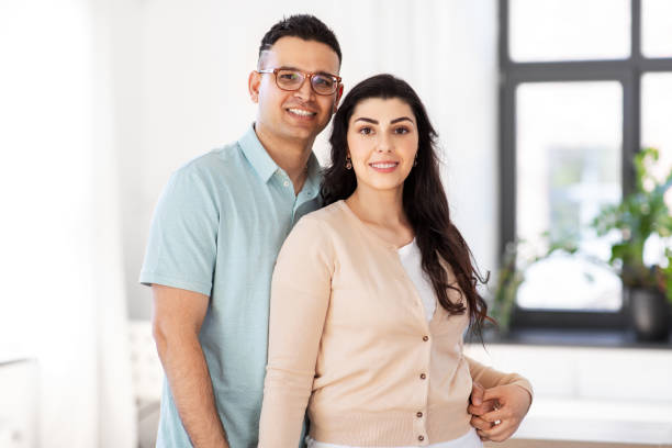istock happy couple hugging at home 1369953125