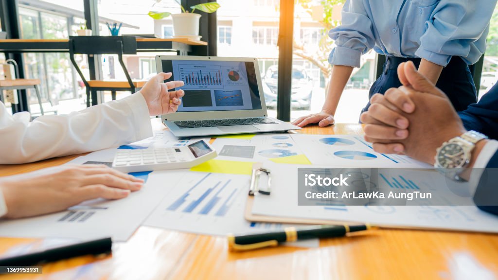 Meeting with business people to discuss and brainstorm ideas on financial reports. The concept of working as a team of financial advisors and accounting, investments with a team at the office. Marketing Stock Photo