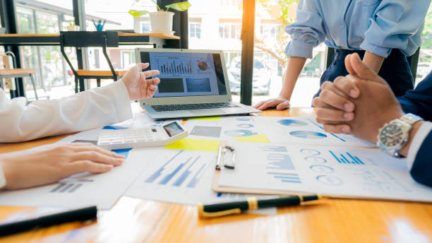 Meeting with business people to discuss and brainstorm ideas on financial reports. The concept of working as a team of financial advisors and accounting, investments with a team at the office. stock photo
