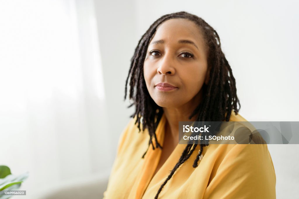 Portrait of an african woman sit on the sofa look worry A Portrait of an african woman sit on the sofa look worry Women Stock Photo