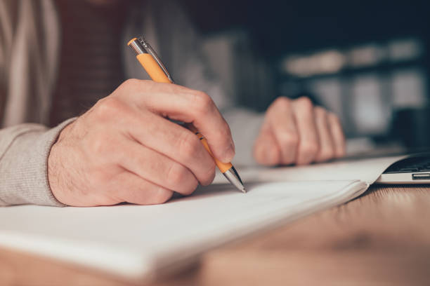 istock Freelance worker writing yo do list at home office desk 1369956534