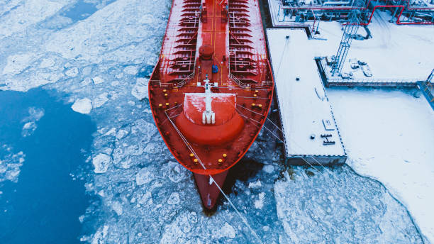 istock Oil shipment on red tanker from terminal system in winter 1369957458