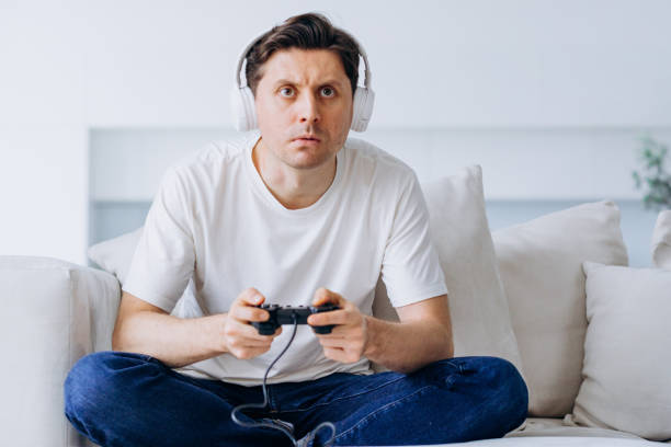 istock Young man plays catch game with controller non-stop and lost 1369957831