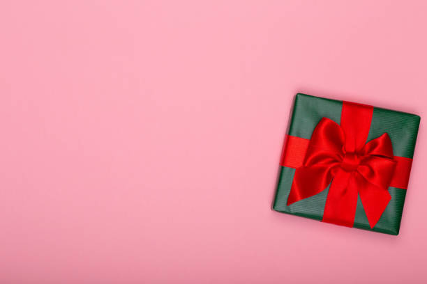istock Gift or present box and stars confetti on color table top view. Flat lay composition for birthday, mother day or wedding. 1369962573