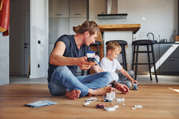 istock Weekend rest. Father and son is indoors at home together 1369963898