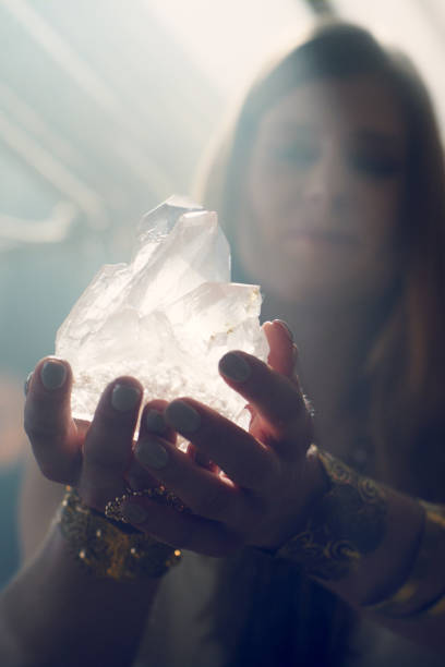 istock Magic ritual in desert tent. Woman's hand with a healing crystal. 1369964429
