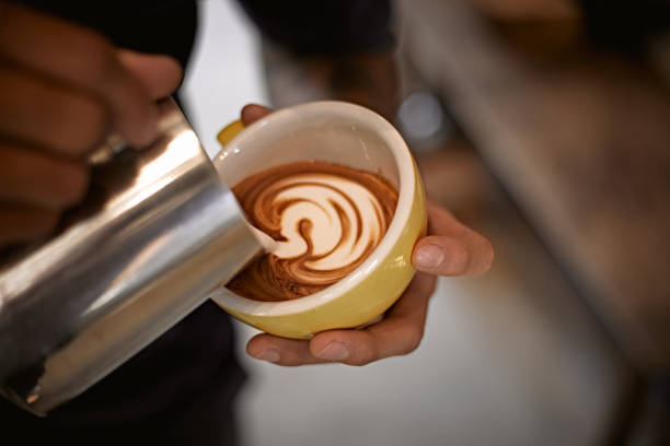 istock Hot latte art making by barista 1369964431