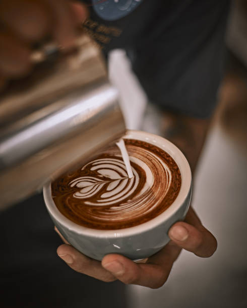 istock Hot latte art making by barista 1369964495