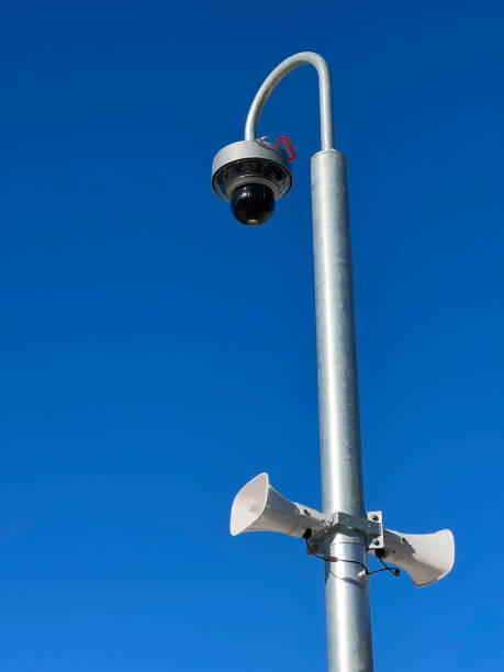 istock Surveillance camera on street lamp background bluesky 1369967688