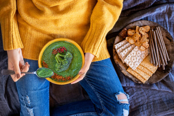 istock A young girl drinks her spinach and broccoli soup at her bed. 1369967883