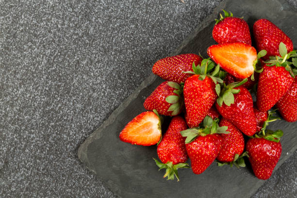 istock strawberry on black floor on marble 1369968949