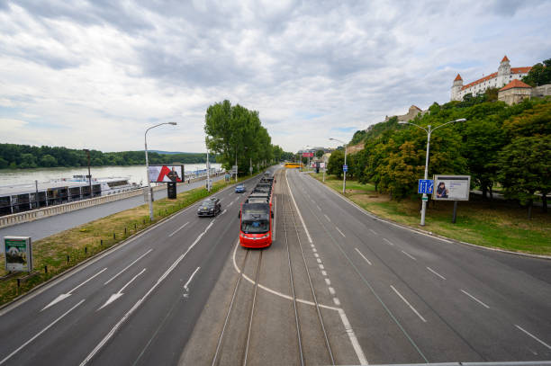 Bratislava, Slovakia - July 9, 2019: A tram passes along the road in front of Bratislava Castle