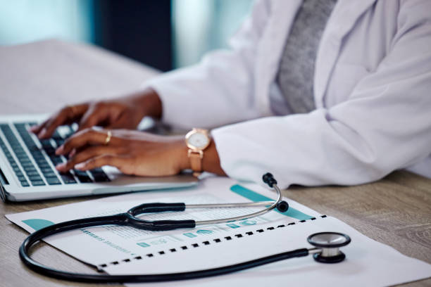 Shot of a female doctor working on her laptop Typing her life away medical record stock pictures, royalty-free photos & images