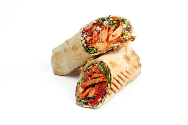 istock Shawarma with chicken, fresh vegetables and red sauce isolated on white background 1369972593