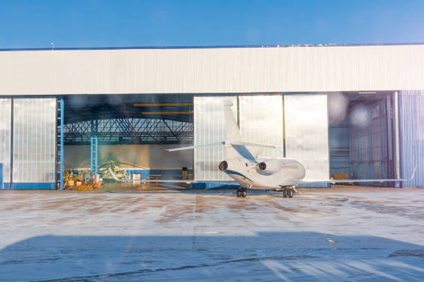 istock Gate open hangar and outside a small jet ready to roll in. 1369972725