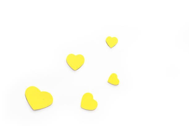 istock Valentine's Day. Isolated yellow hearts on a white background, top view, copy space 1369973395
