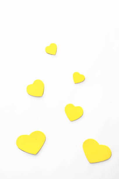 istock Valentine's Day. Isolated yellow hearts on a white background, top view, copy space 1369973445