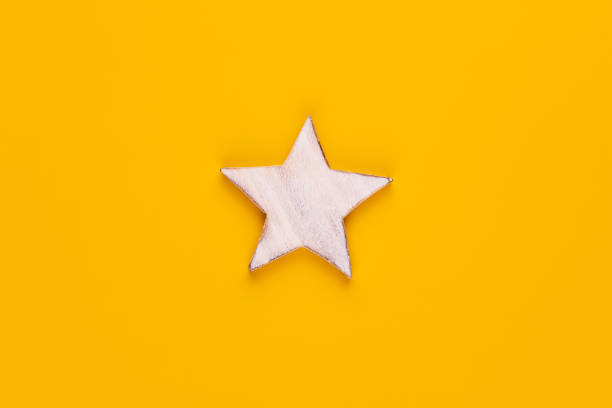 istock Christmas star decor on yellow colored background. 1369974106