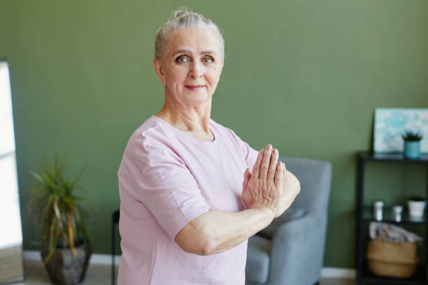 istock Senior woman doing yoga 1369974639